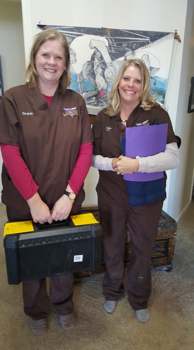 Dr. Erin (left) and Patrice in their scrubs, with their house-call kit